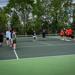 Minneapolis Roosevelt Boys Tennis team gathers on the court with Minneapolis South players at the start of a match