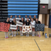 volleyball team holding "1,000 Digs" signs