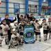 Members of Jr. Bears Mite A and coaches holding championship banner