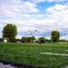 A football player clicking a football at the Edina Football field