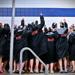 girls swim team celebrating on pool deck
