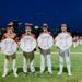 Four Teddy baseball Seniors pose together under the lights at Parade Stadium