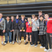 The White Hawks wrestlers pose after their first place finish at Fridley