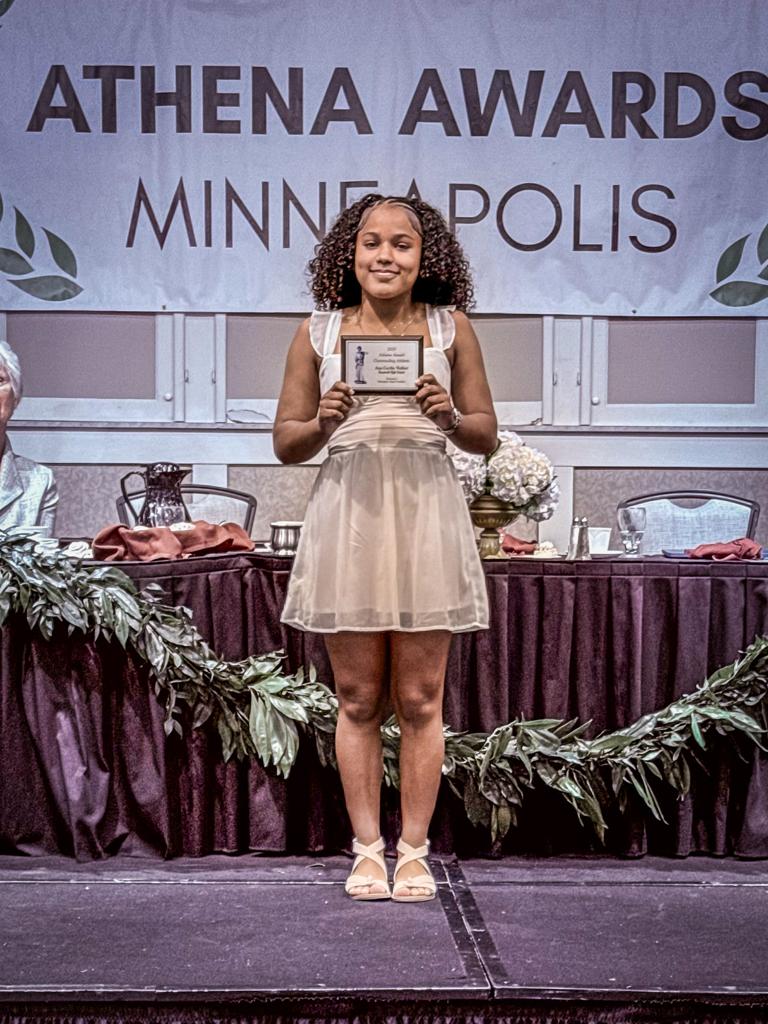 Ana Cecilia Walker on stage receiving her award at the Athena banquet