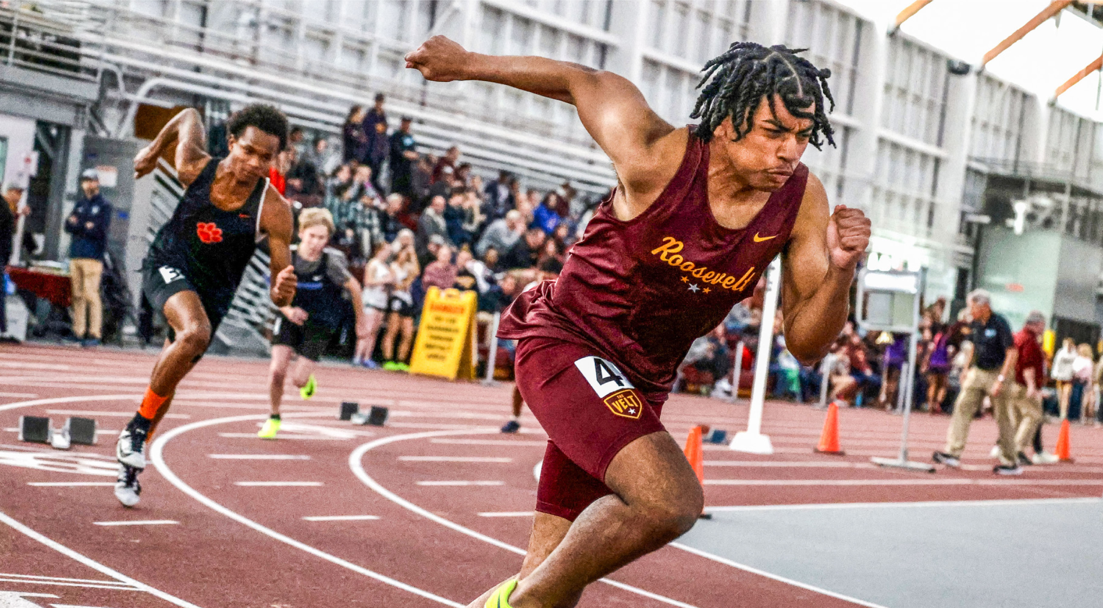 Image of a Minneapolis Roosevelt High School Teddy Track sprinter close up. He bursts out of the blocks in the 200m event
