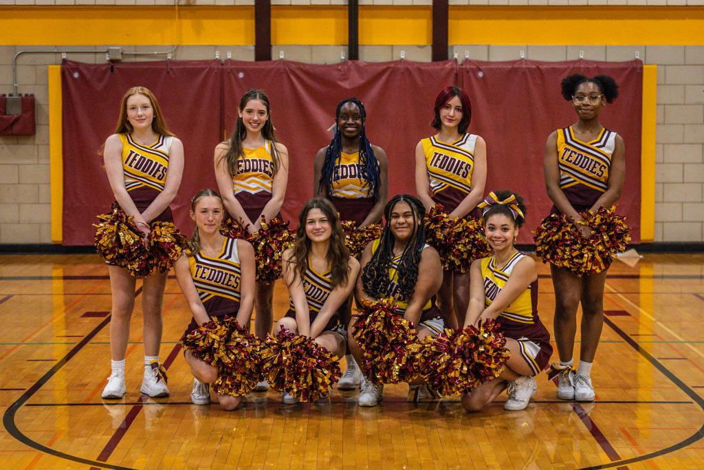 Minneapolis Roosevelt Basketball Cheerleading squad pose on the court at Jack Wells Gymnasium